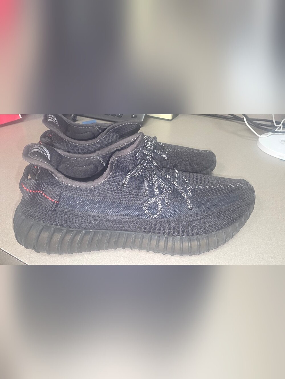 adidas Black Knit Low-Top Yeezys with Reflective Laces and Red Stitch Accent